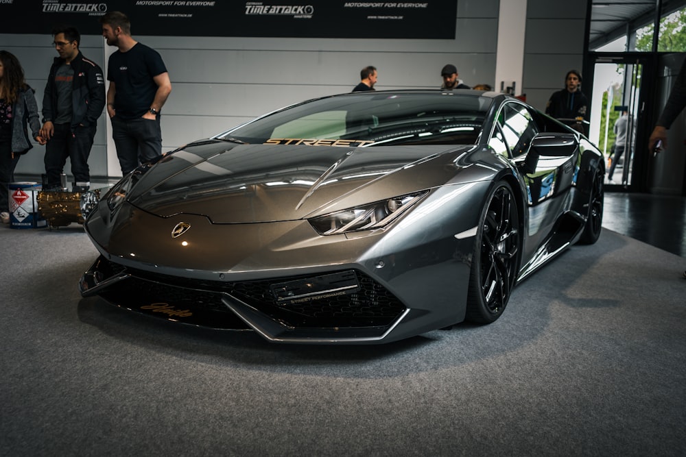 a metallic sports car is on display at a car show