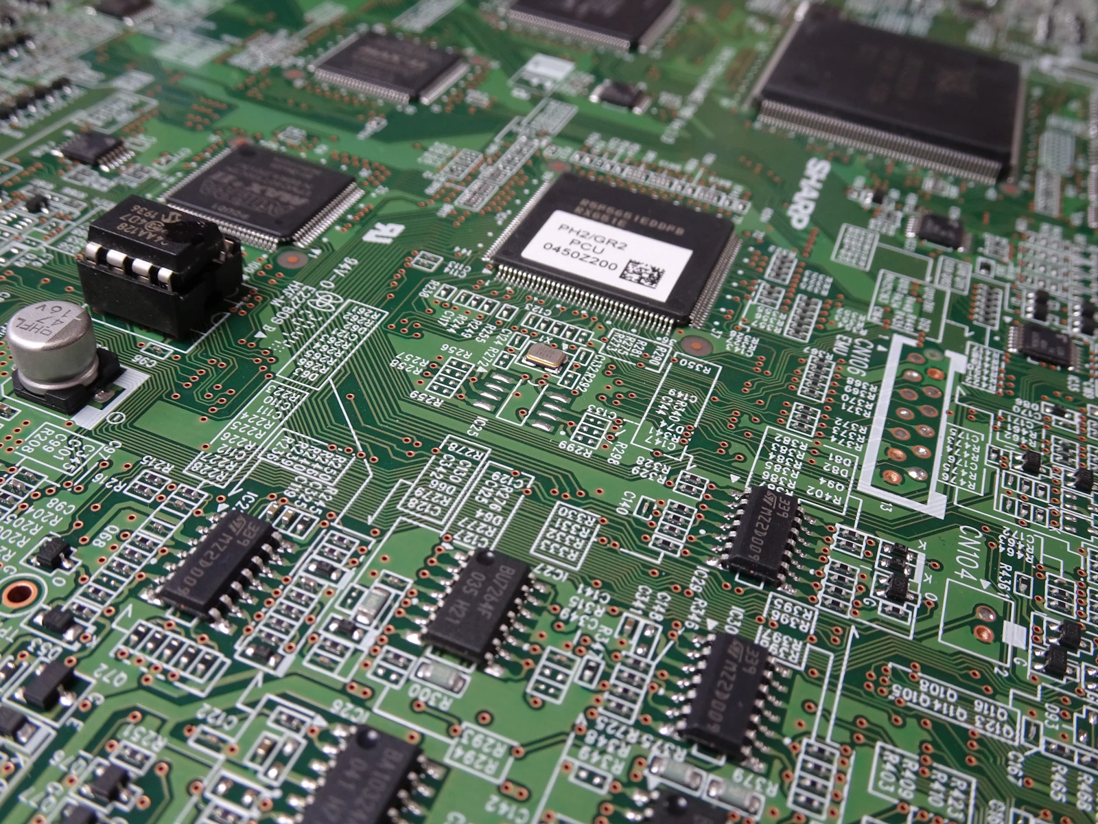 Close-up macro of a logic board during precision component-level repair