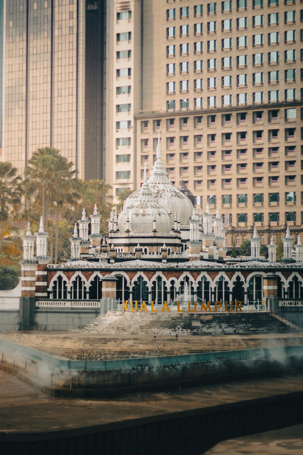 a large building with a white dome in the middle of a city