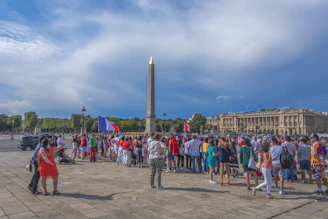 A peaceful crowd walking from Place de la République to Place du Trocadéro under a clear sky.