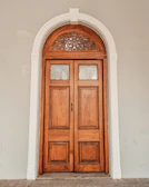 Classic white door with decorative molding and brass knob.