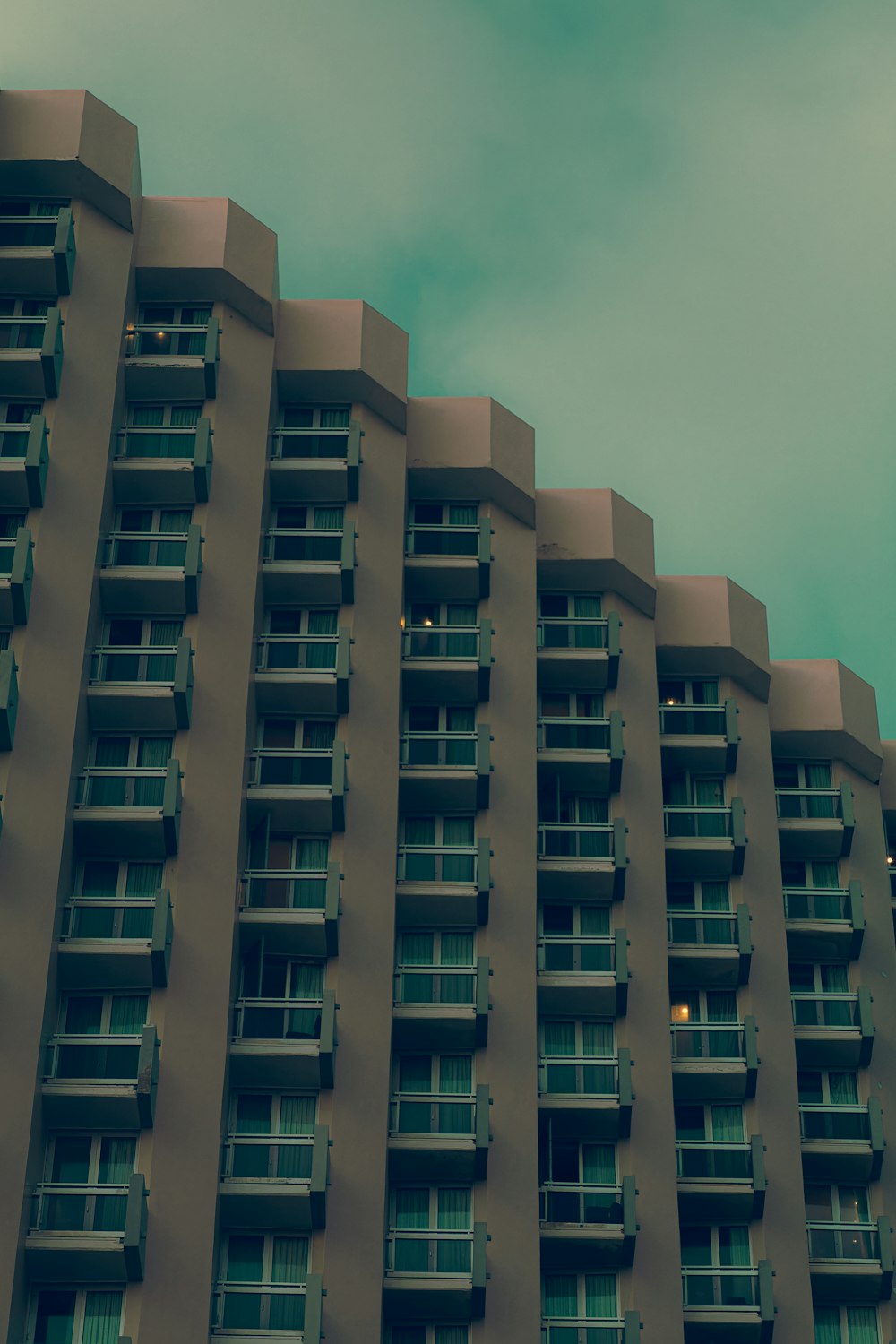 a tall building with balconies on the top of it