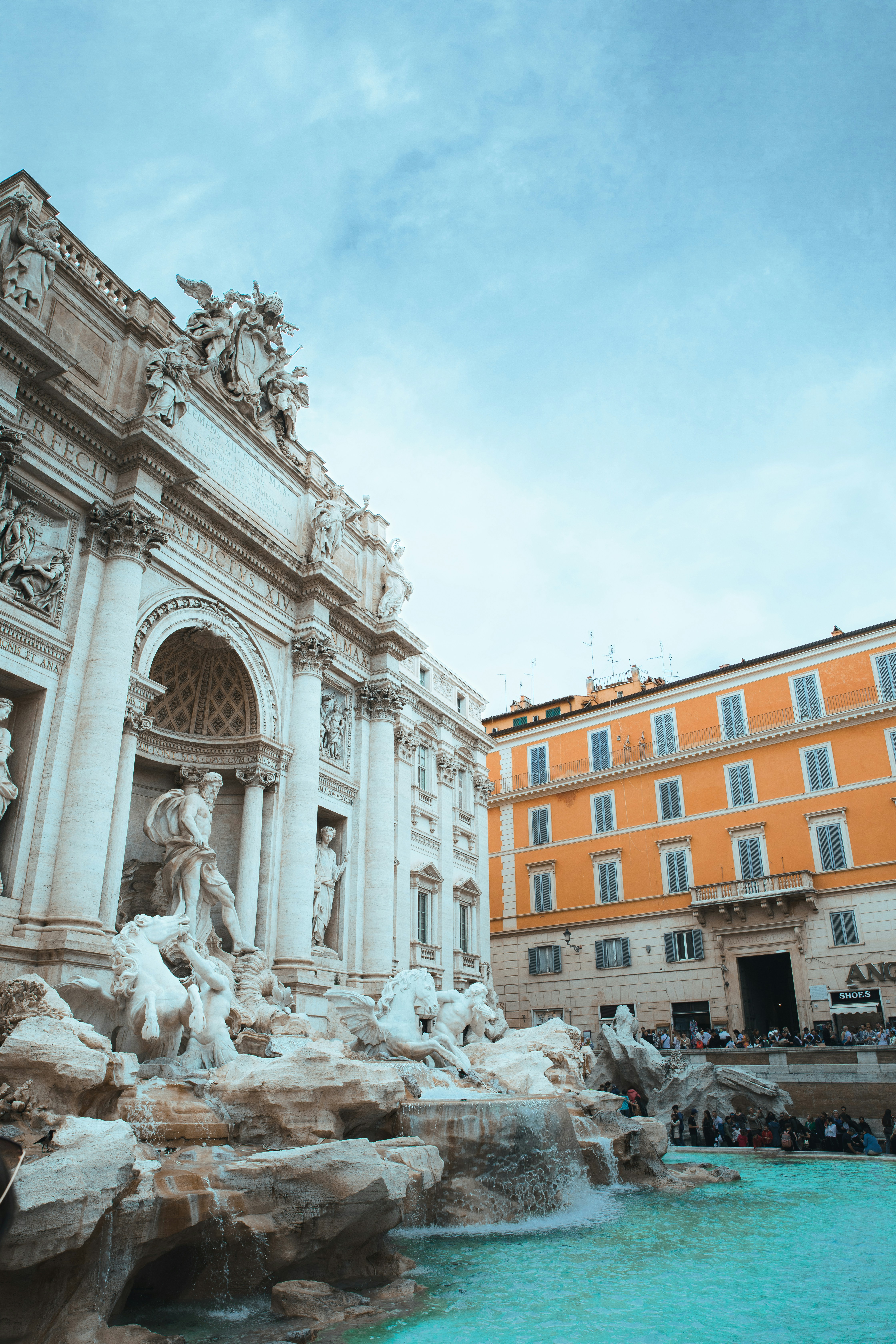a large building with a fountain in front of it