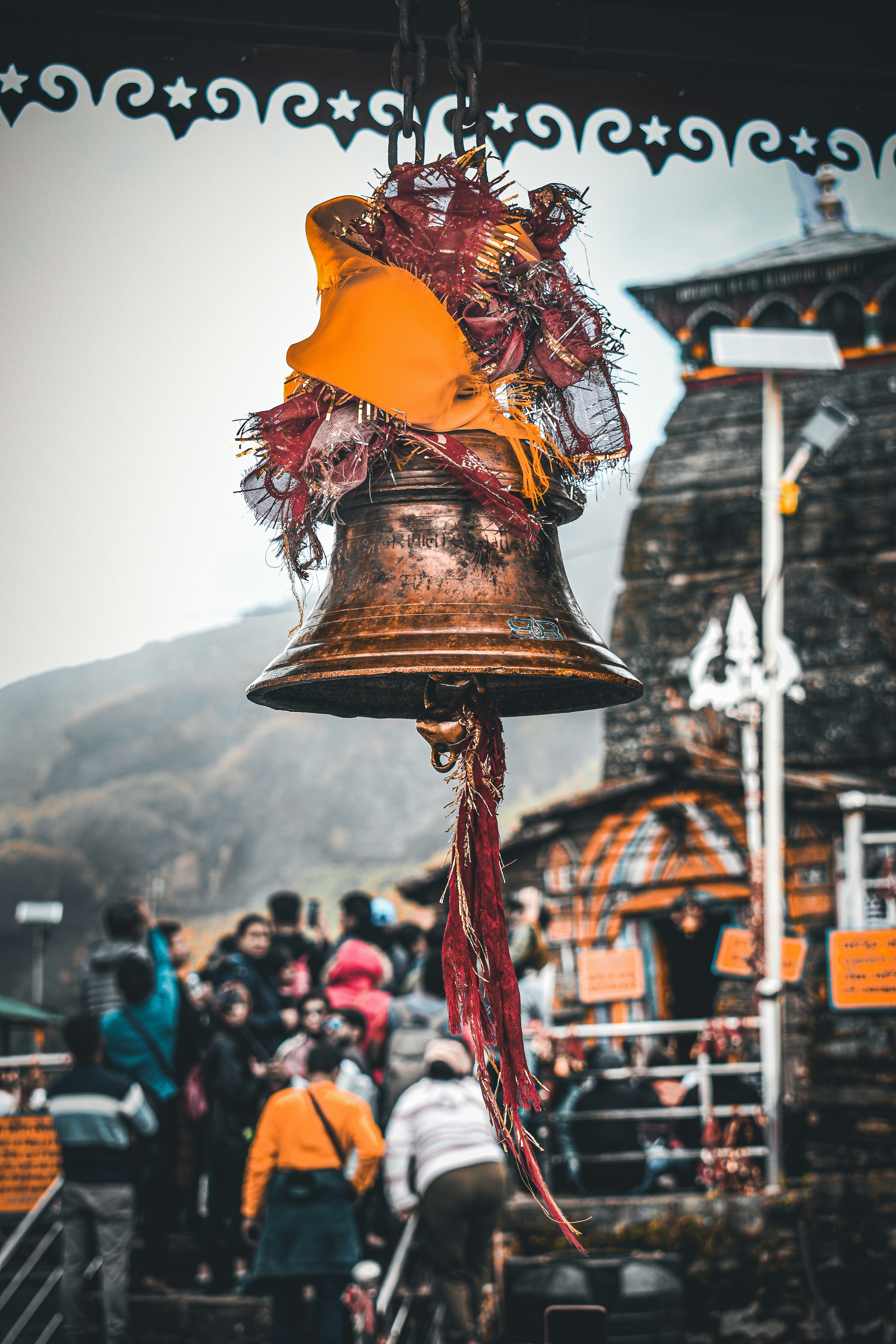 a bell with a red ribbon hanging from it