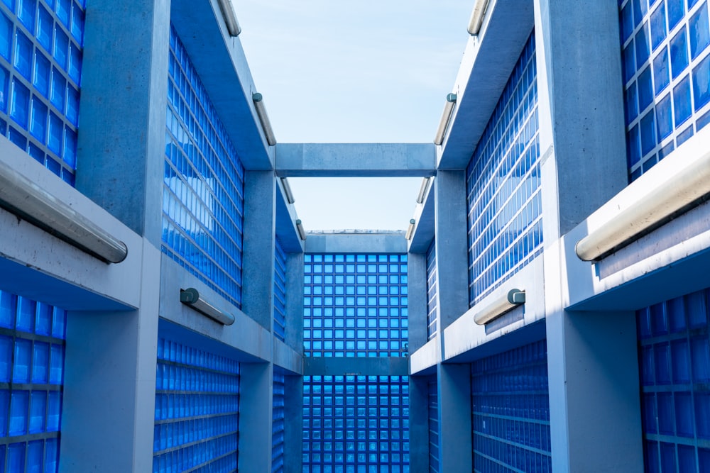 a hallway with blue glass blocks and a sky background