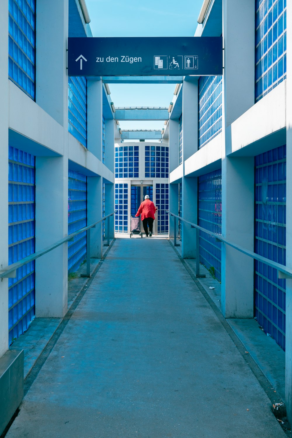 a person with a suitcase walking down a hallway