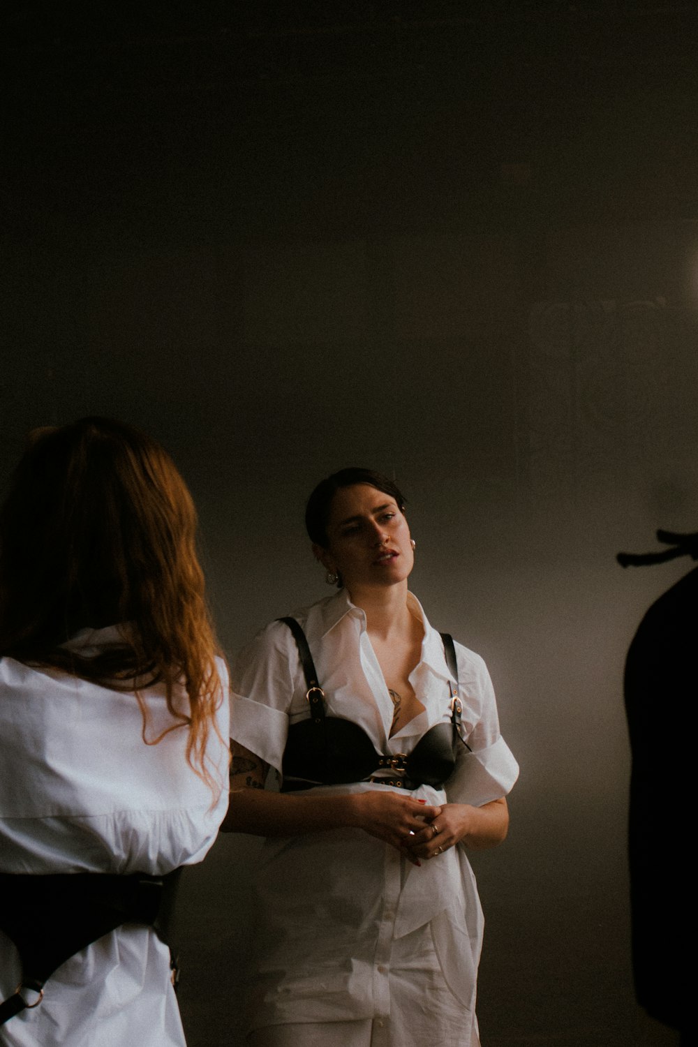 a woman in a white shirt and black suspenders