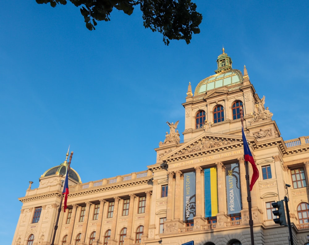 a large building with flags flying in front of it