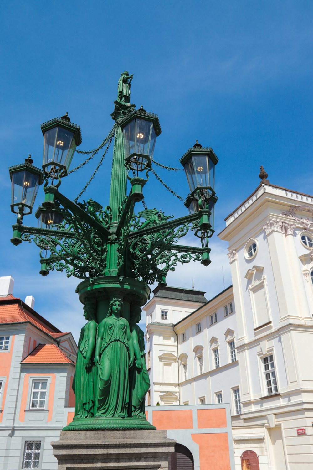 a street light with a statue on top of it