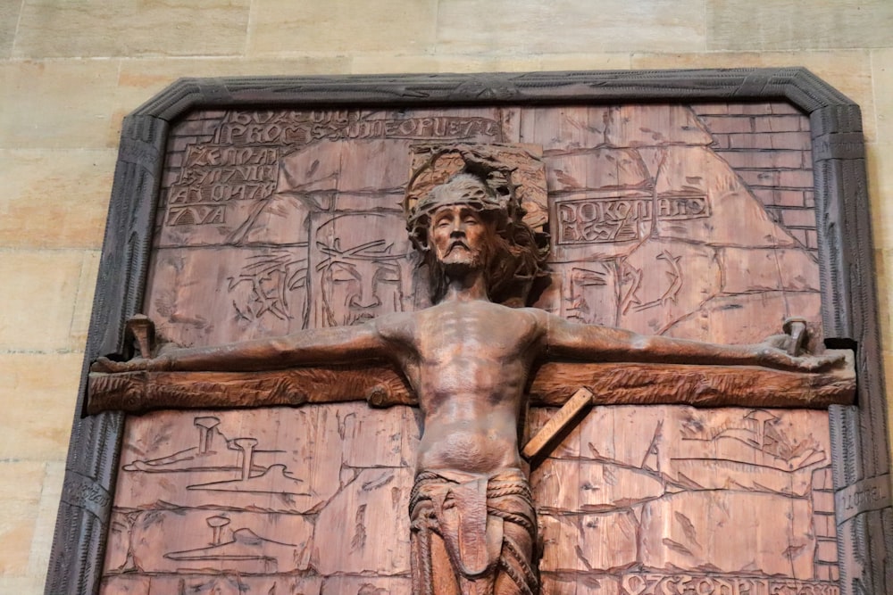 a wooden crucifix with a carving of jesus on it