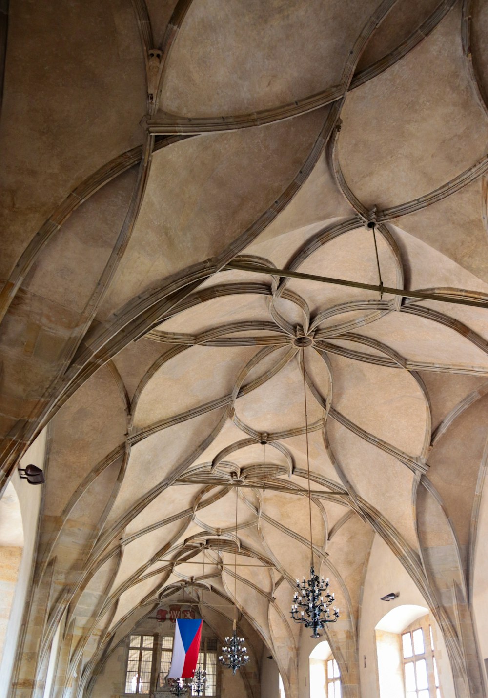 a large room with a vaulted ceiling and chandeliers