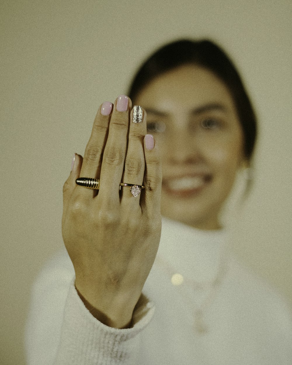 a woman holding her hand up to the camera