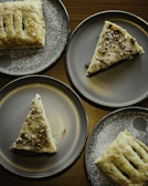 An inviting dessert plate featuring traditional Romanian sweets with a dusting of powdered sugar.