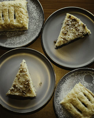 An inviting dessert plate featuring traditional Romanian sweets with a dusting of powdered sugar.