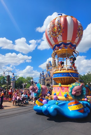 A candid shot of a family enjoying a classic Disney parade with colorful floats.