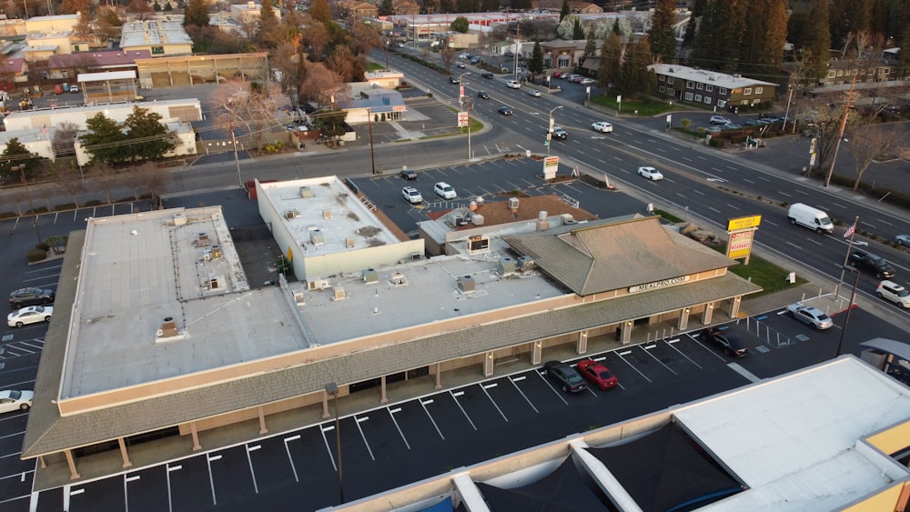 an aerial view of a parking lot and a building