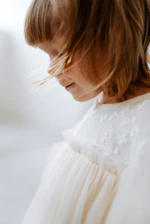 A softly lit portrait of a child in whimsical fashion, capturing innocence and style.