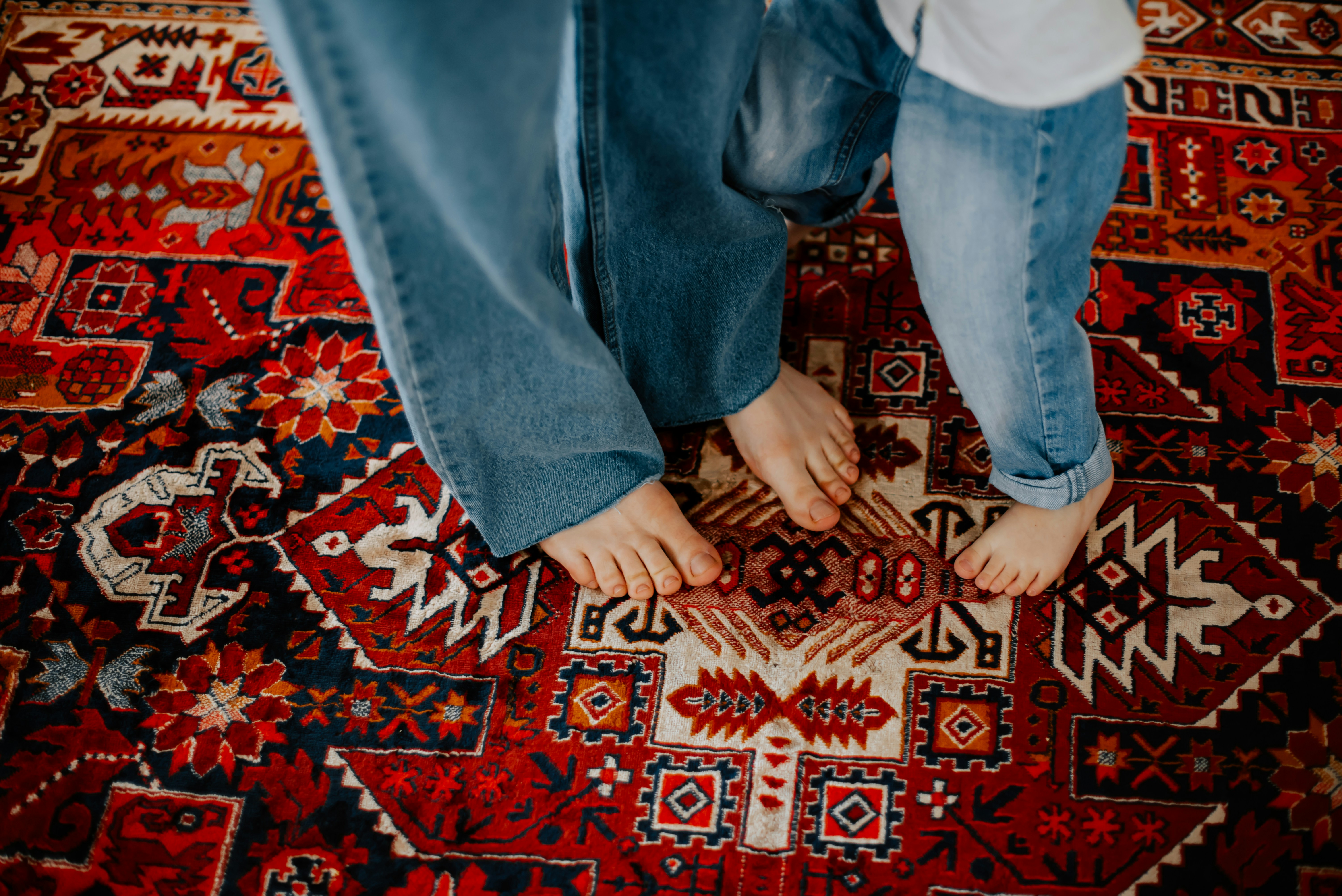 A person standing on top of a red rug photo – Free Boy Image on Unsplash