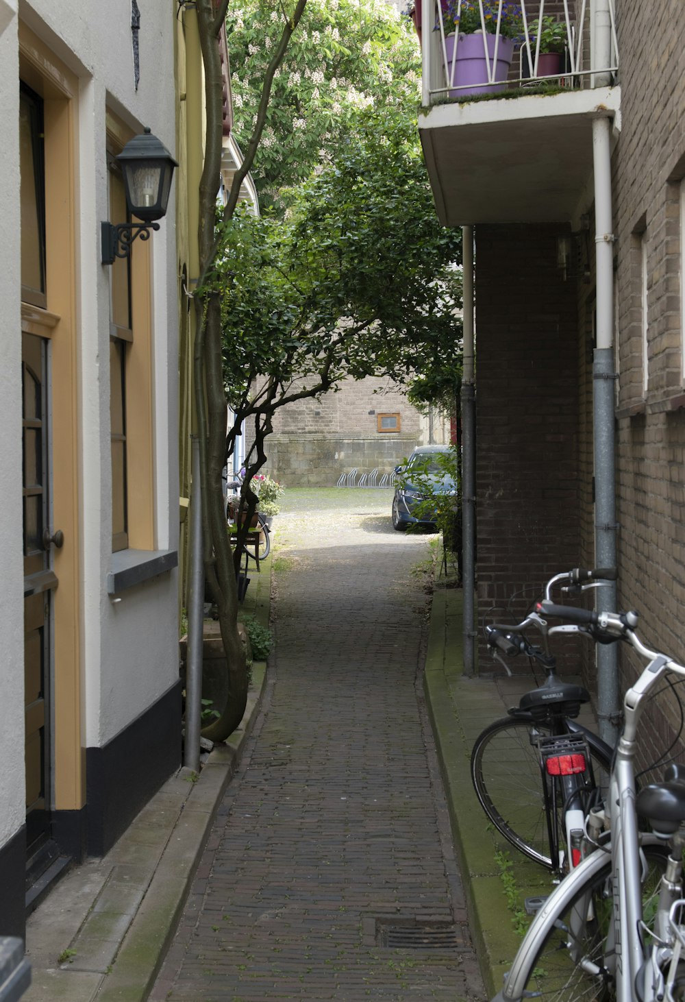 a bike parked on the side of a street next to a building