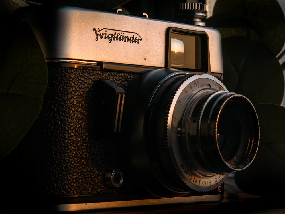 an old fashioned camera sitting on top of a wooden table