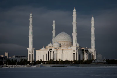 The white Hazrat Sultan mosque in Astana under a grey steppe sky