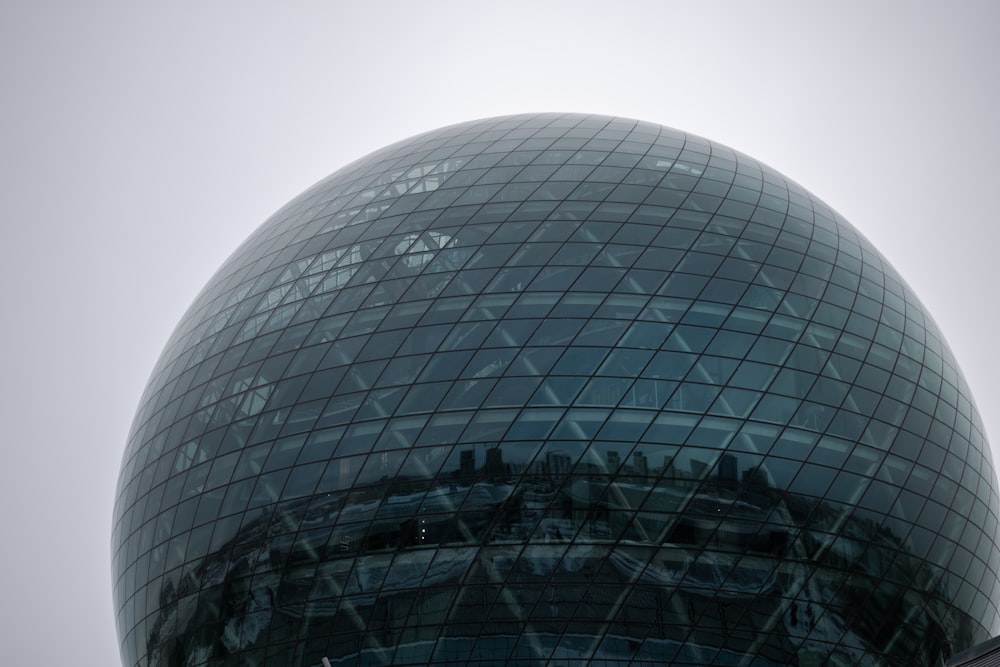 a large glass building with a circular roof