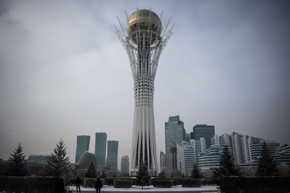 a tall tower with a golden dome in the middle of a city