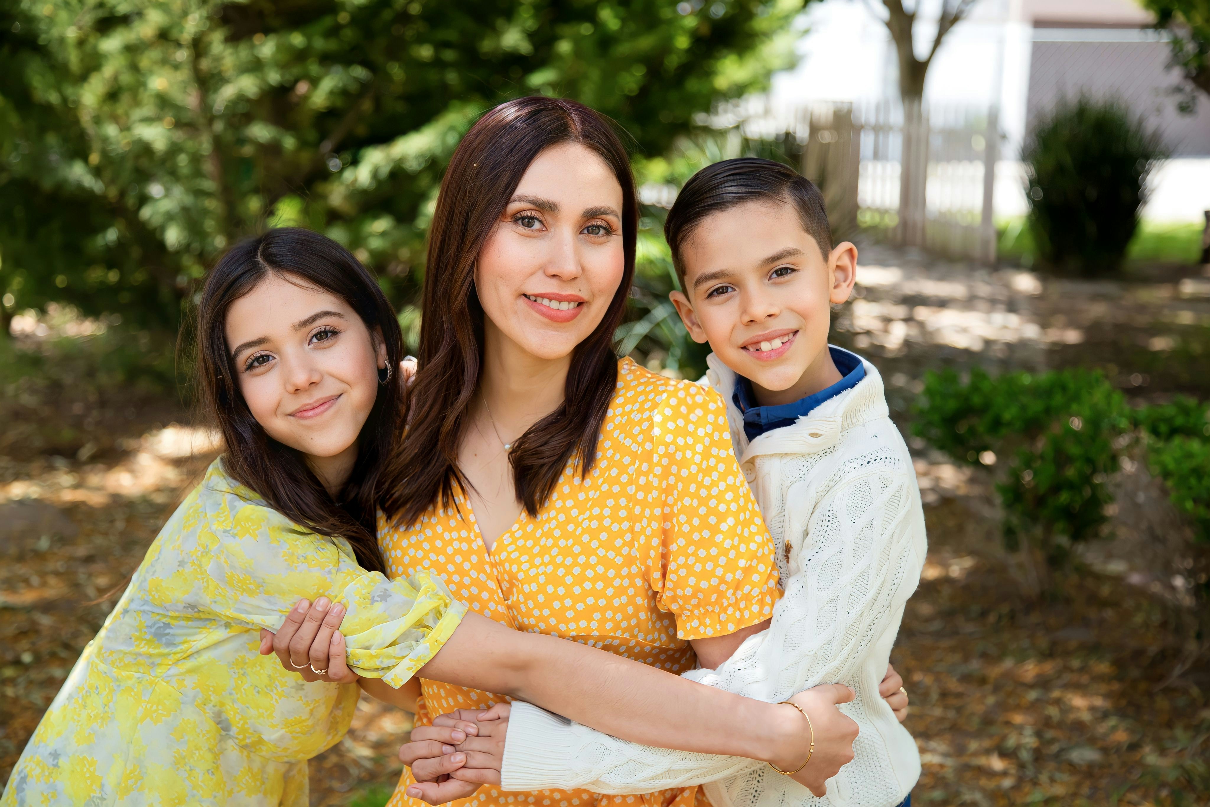 Portrait of Ana Solis, a mother smiling happily with natural background