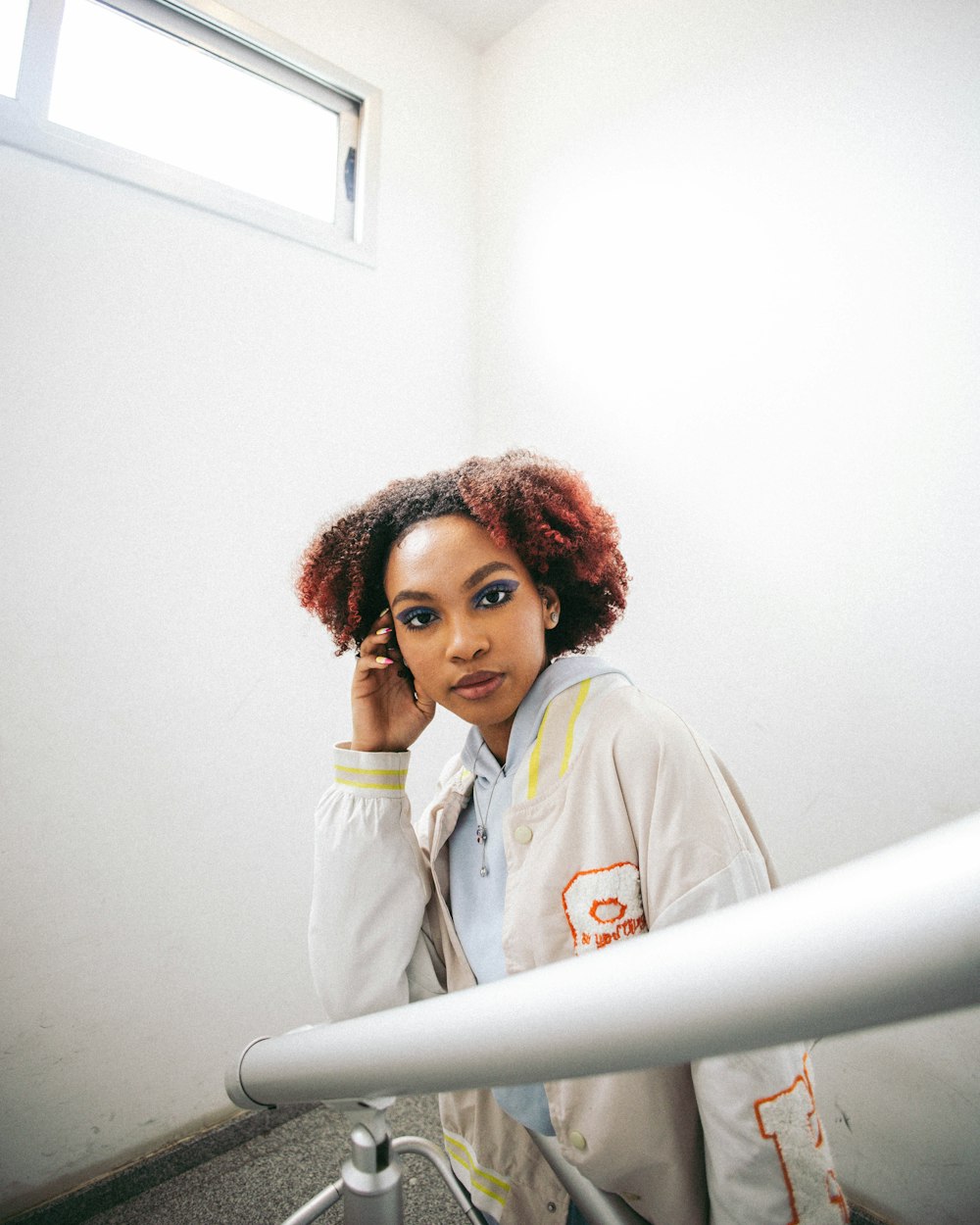 a woman with red hair standing in a room