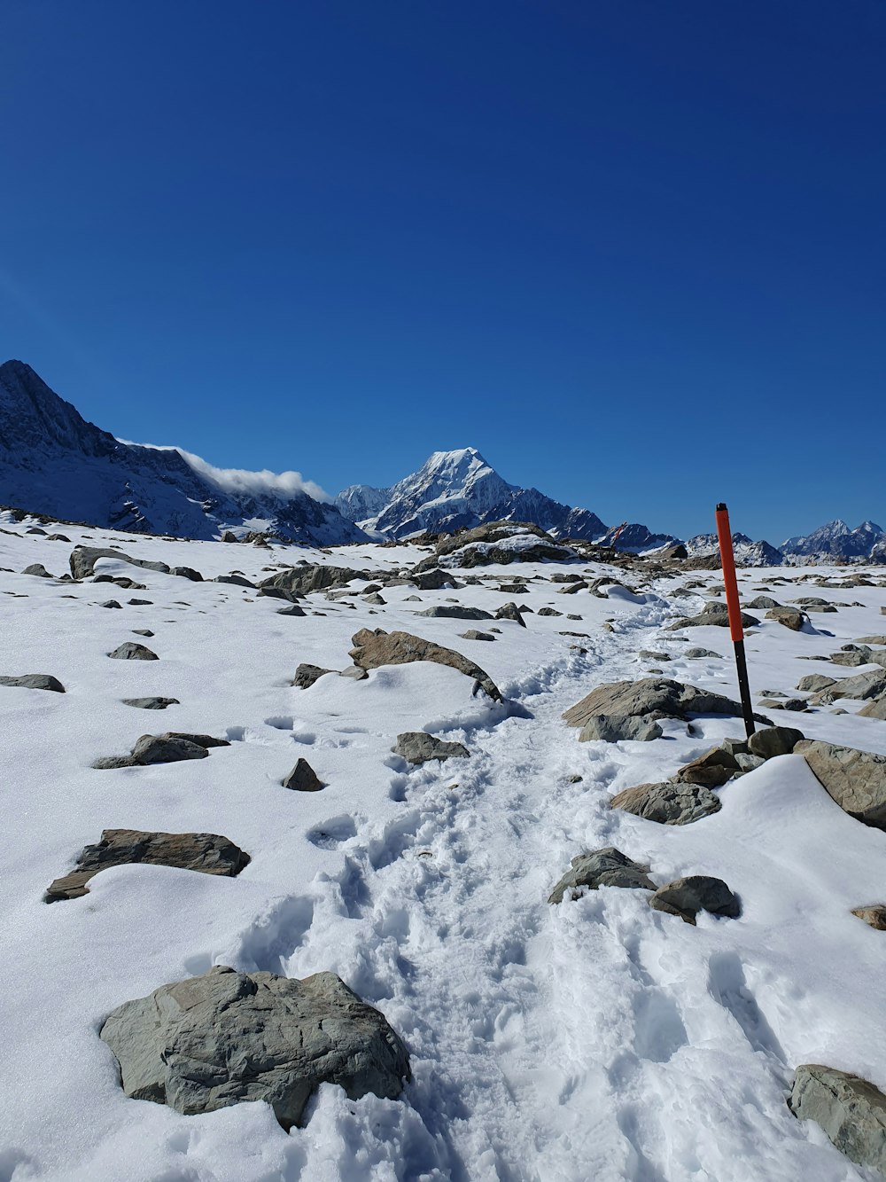 a trail in the middle of a snow covered field