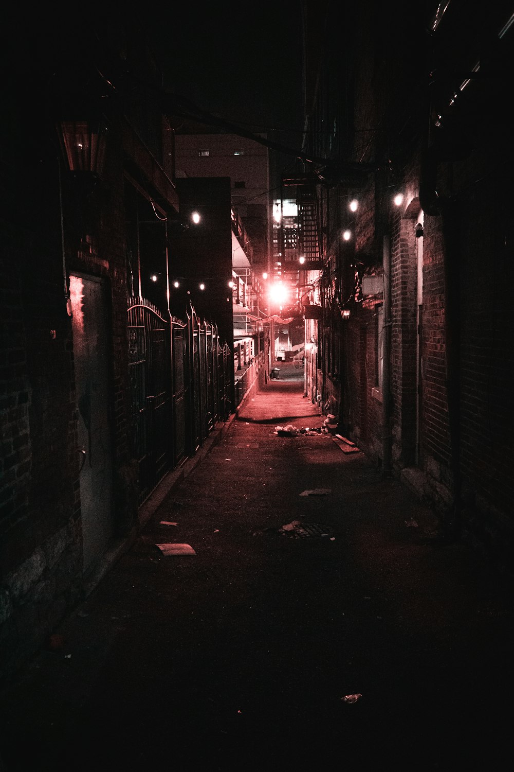 a dark alley way with a street light at night