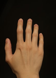 a close up of a person's hand with a black background