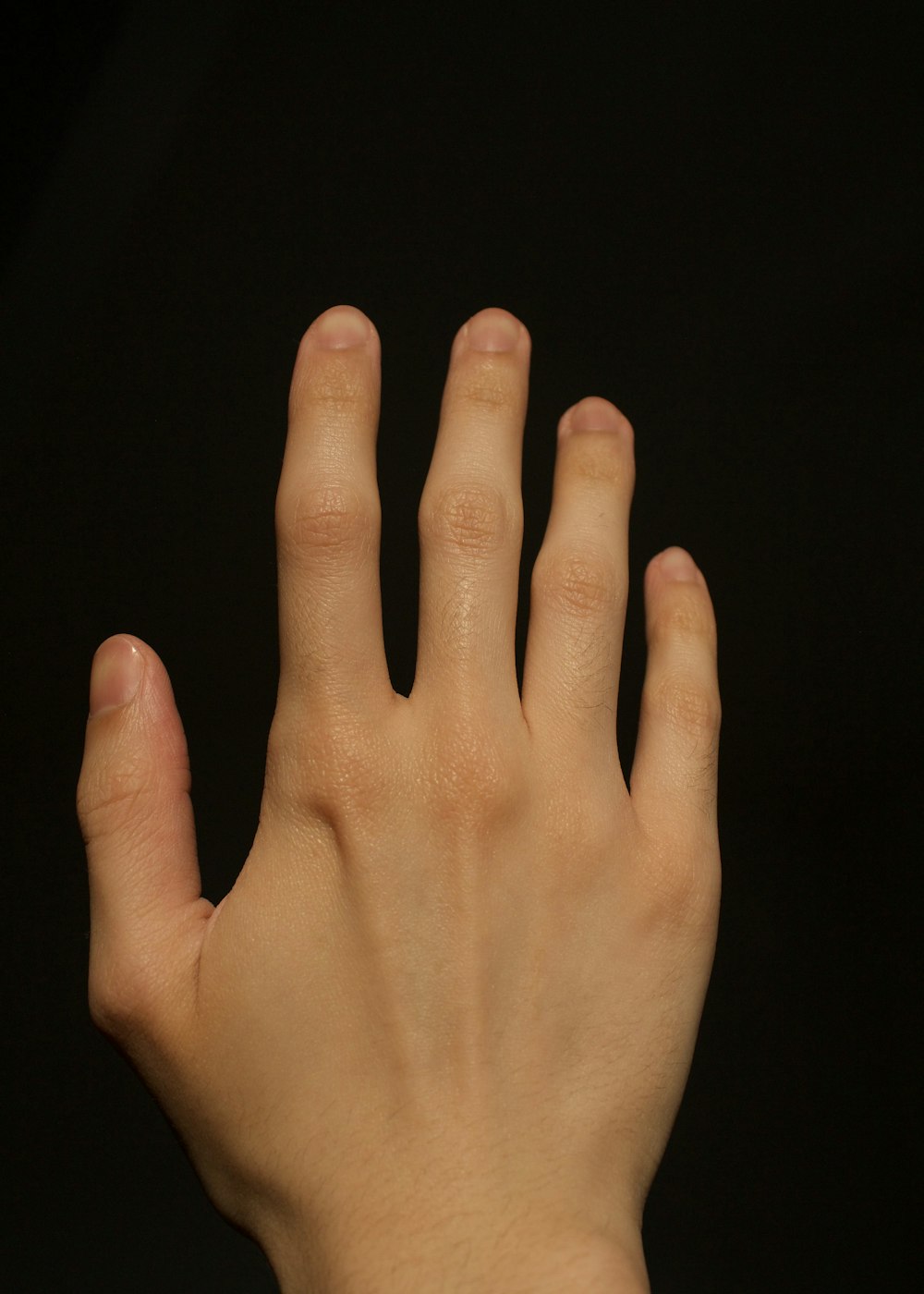 a close up of a person's hand with a black background