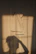 Close-up of a soft, plush towel in warm beige tones draped over a bathroom rack.
