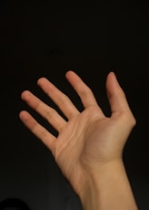 a person holding their hand up in the air