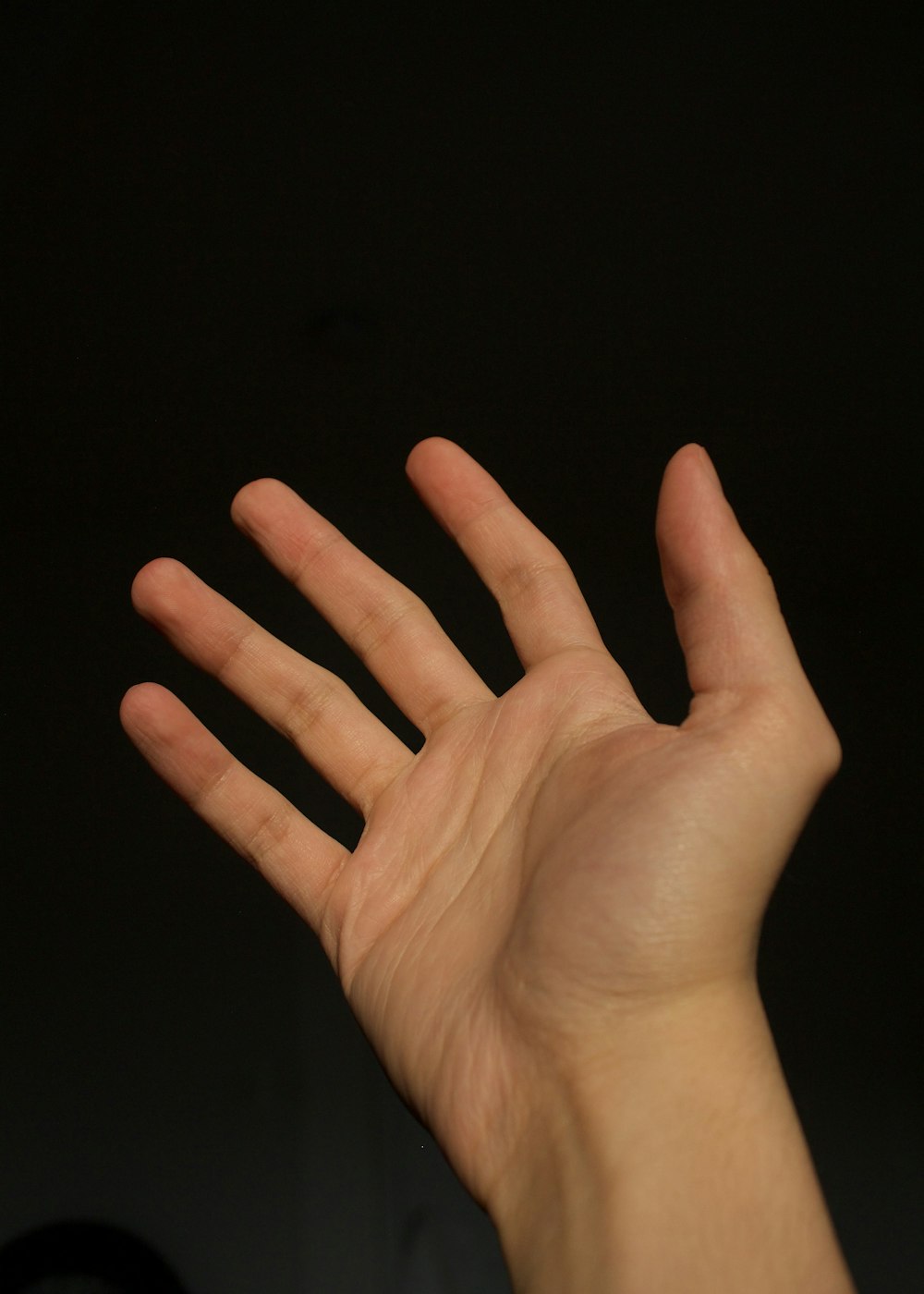 a person holding their hand up in the air