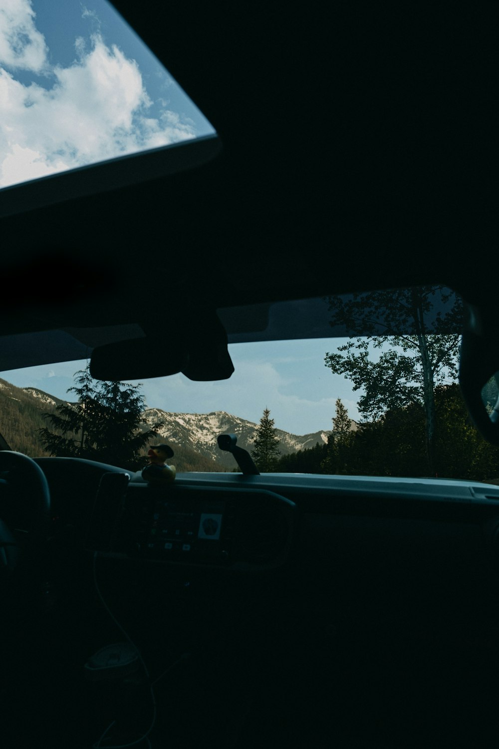 a view of mountains from inside a car