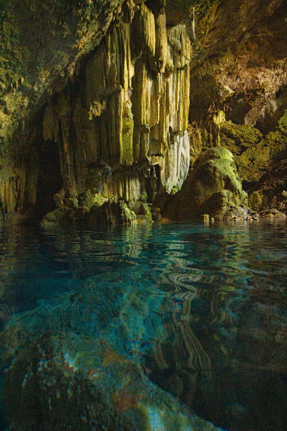 a cave with a pool of water in the middle of it