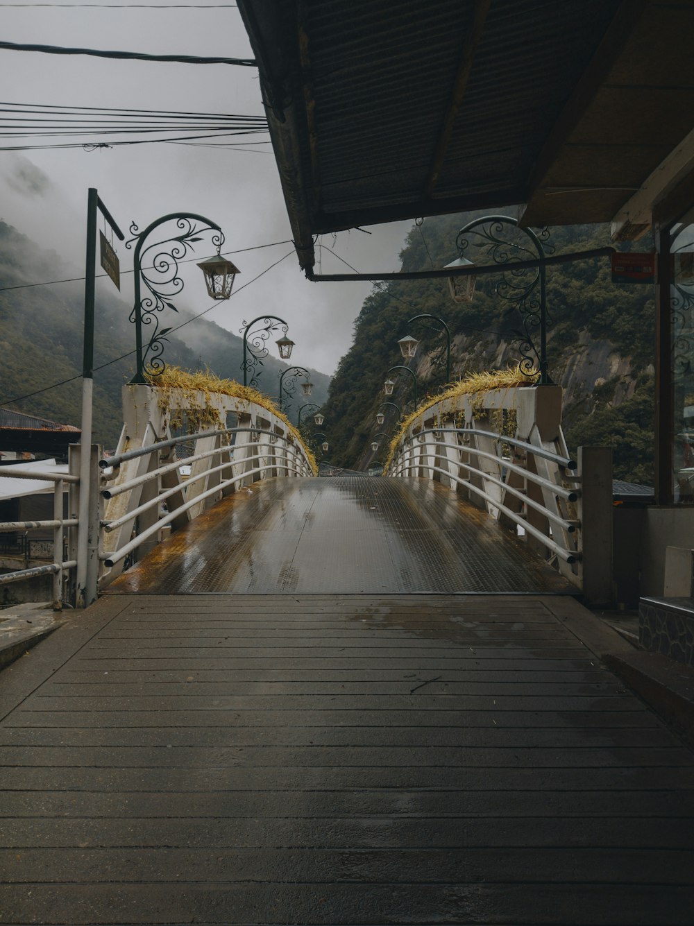 a wooden bridge with a lantern hanging from it's side