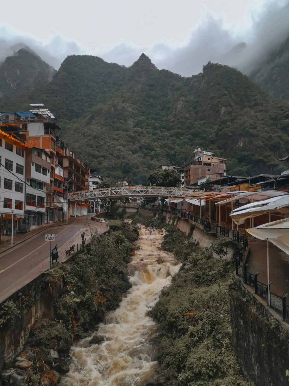 a river running through a city next to tall buildings