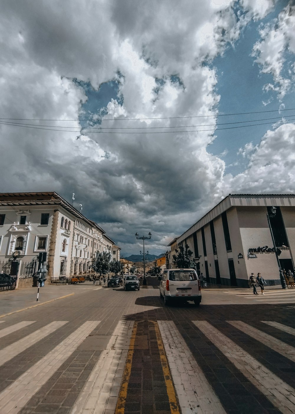 a cloudy sky is seen over a city street