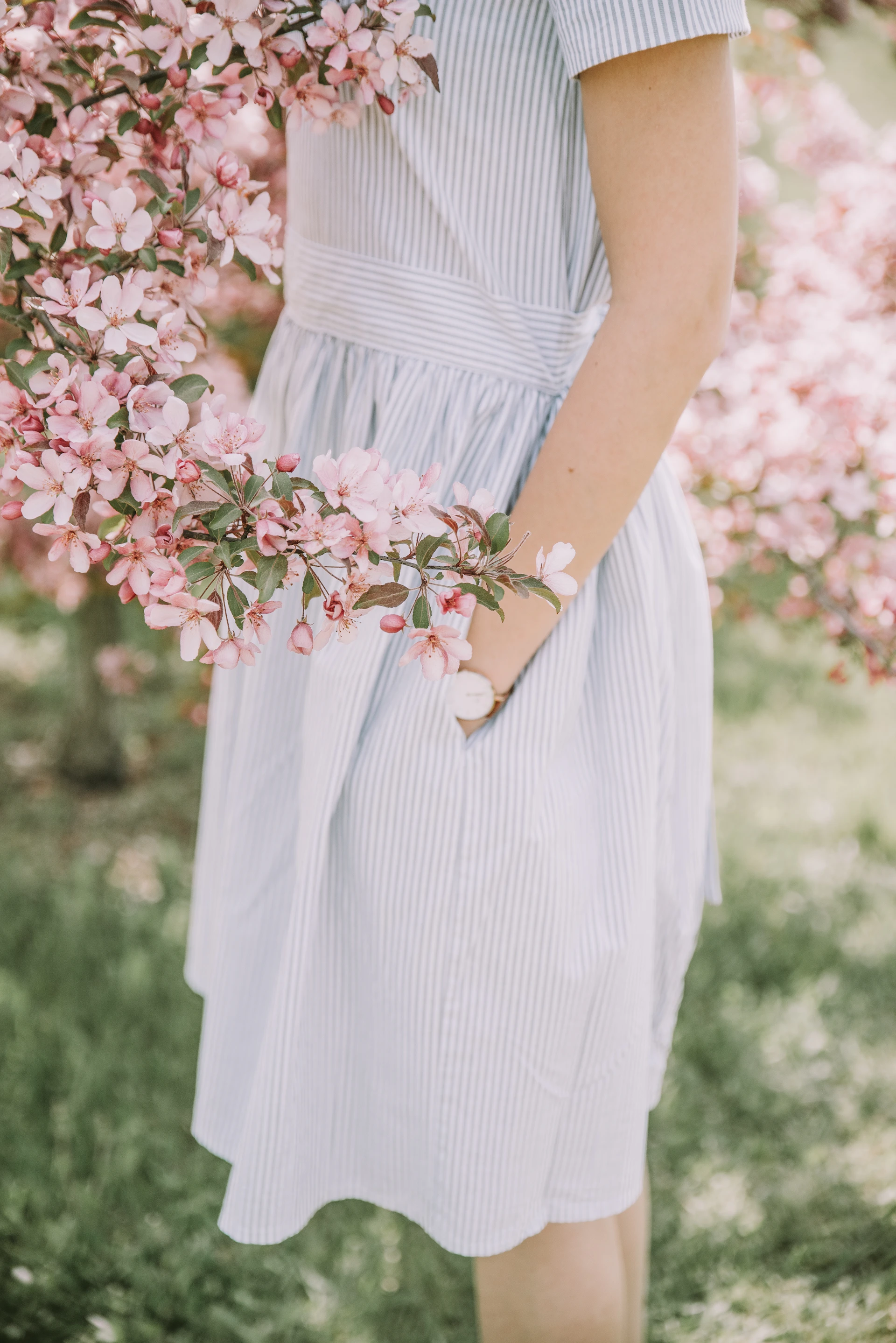 a woman in a dress holding a bunch of flowers