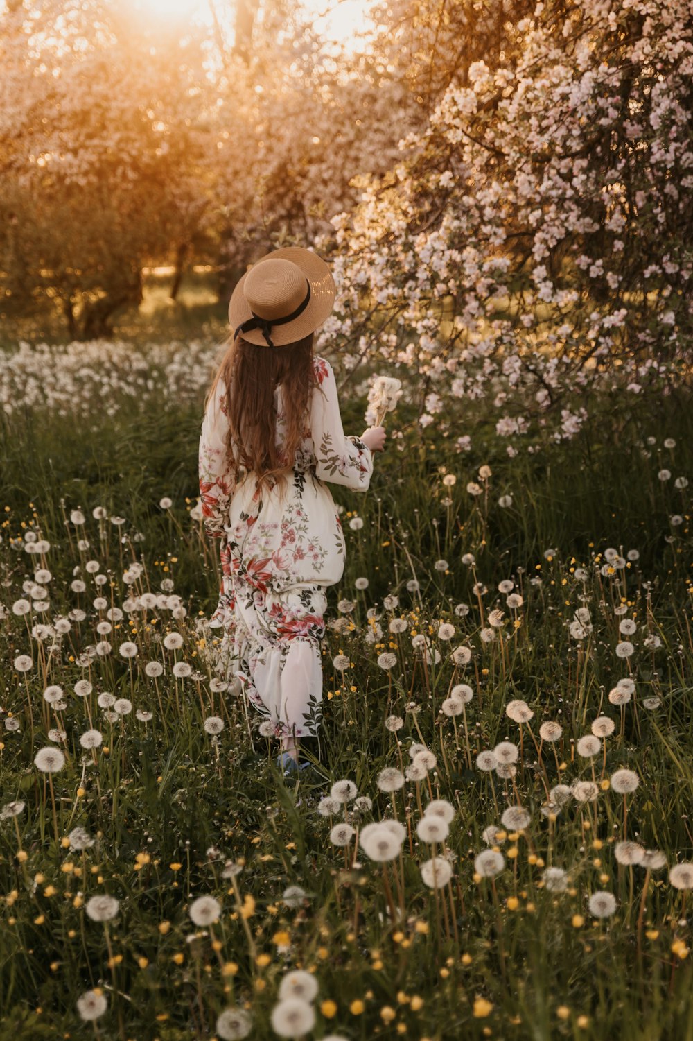 a woman standing in a field of flowers