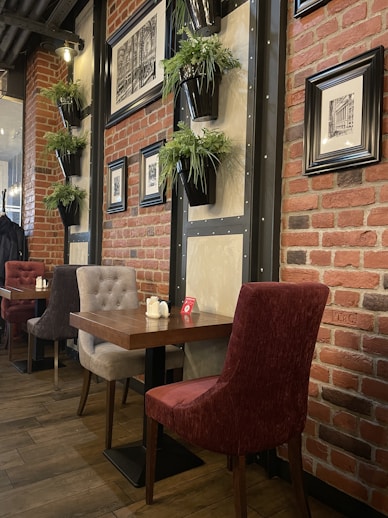 a restaurant with a brick wall and wooden tables