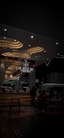 A sleek modern café interior with curved design elements and warm lighting.