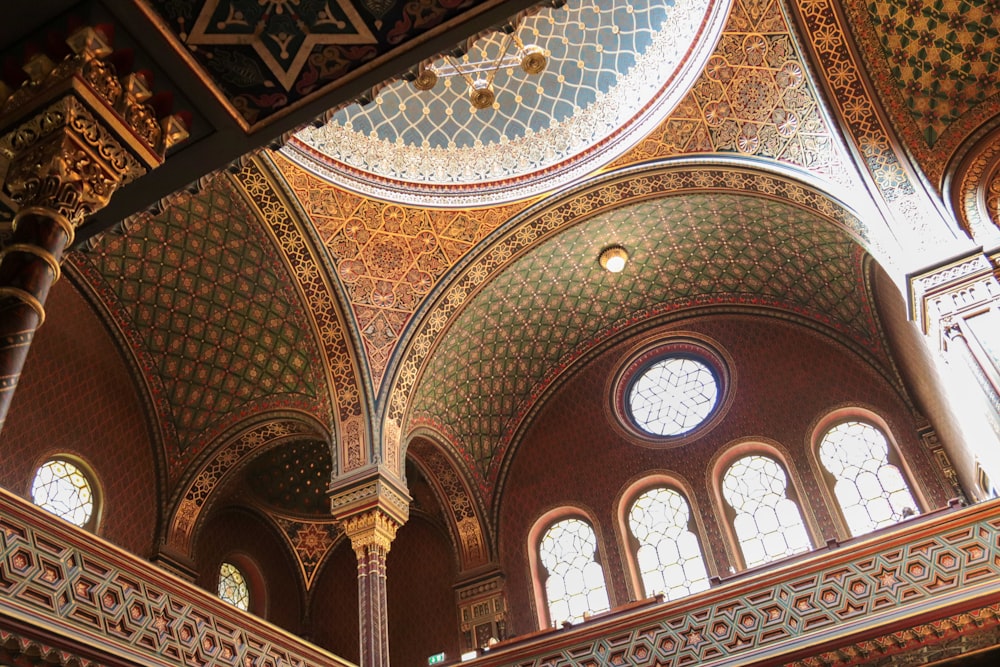 the ceiling of a large building with many windows