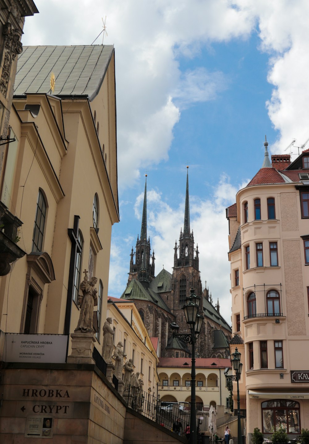 a city street with buildings and a church in the background