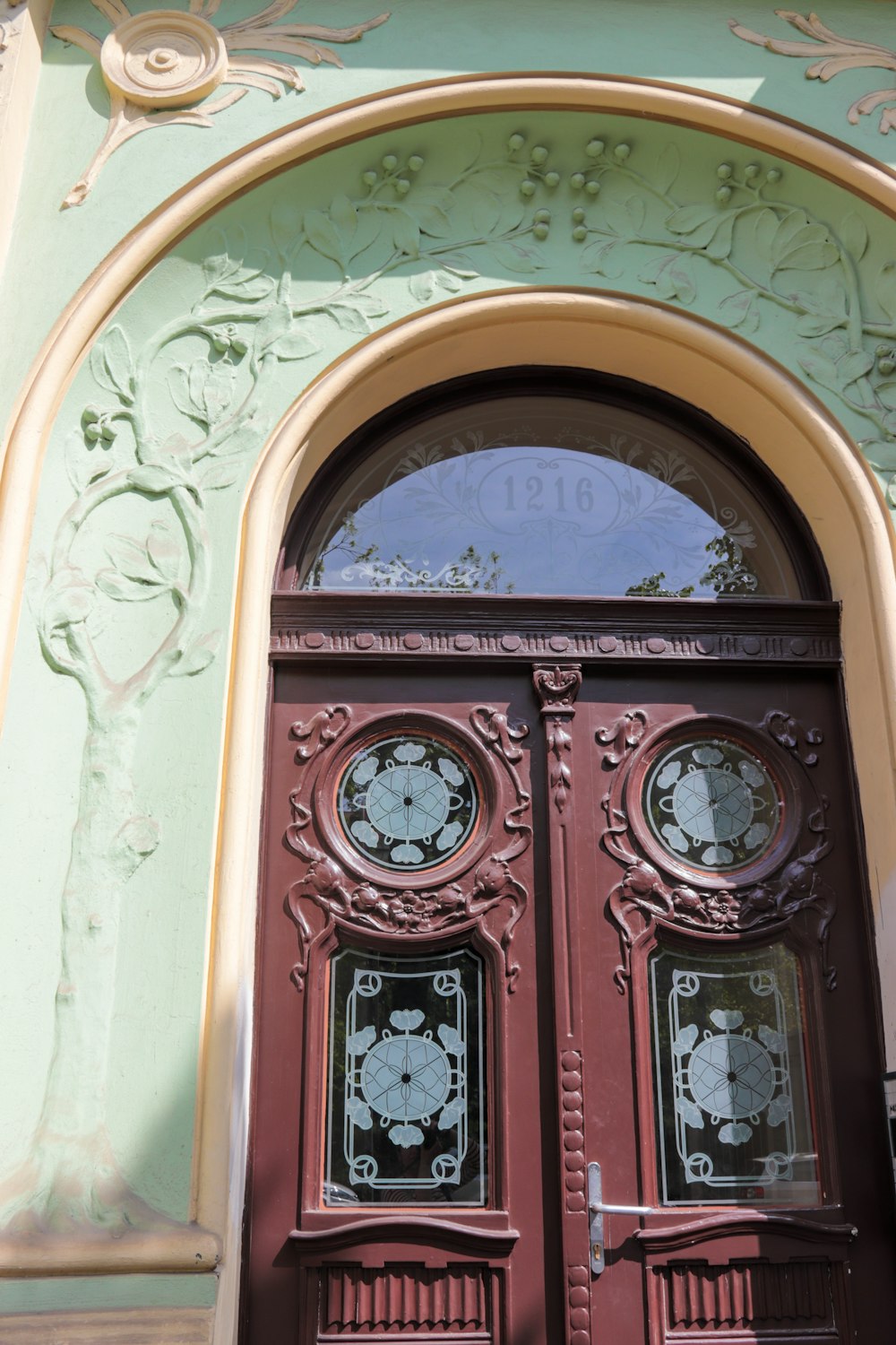 a red door with a clock on the side of it