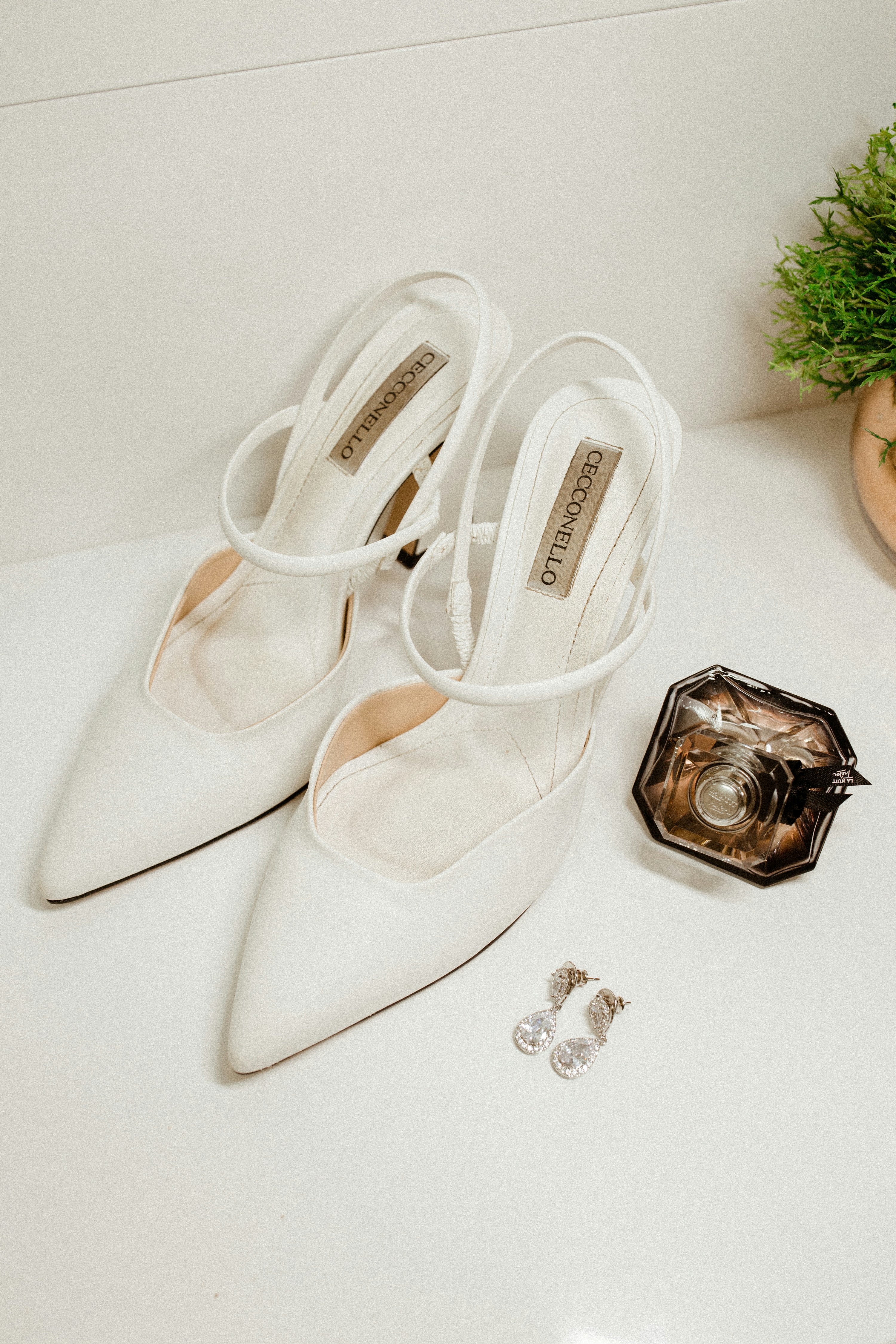 a pair of white shoes sitting on top of a table