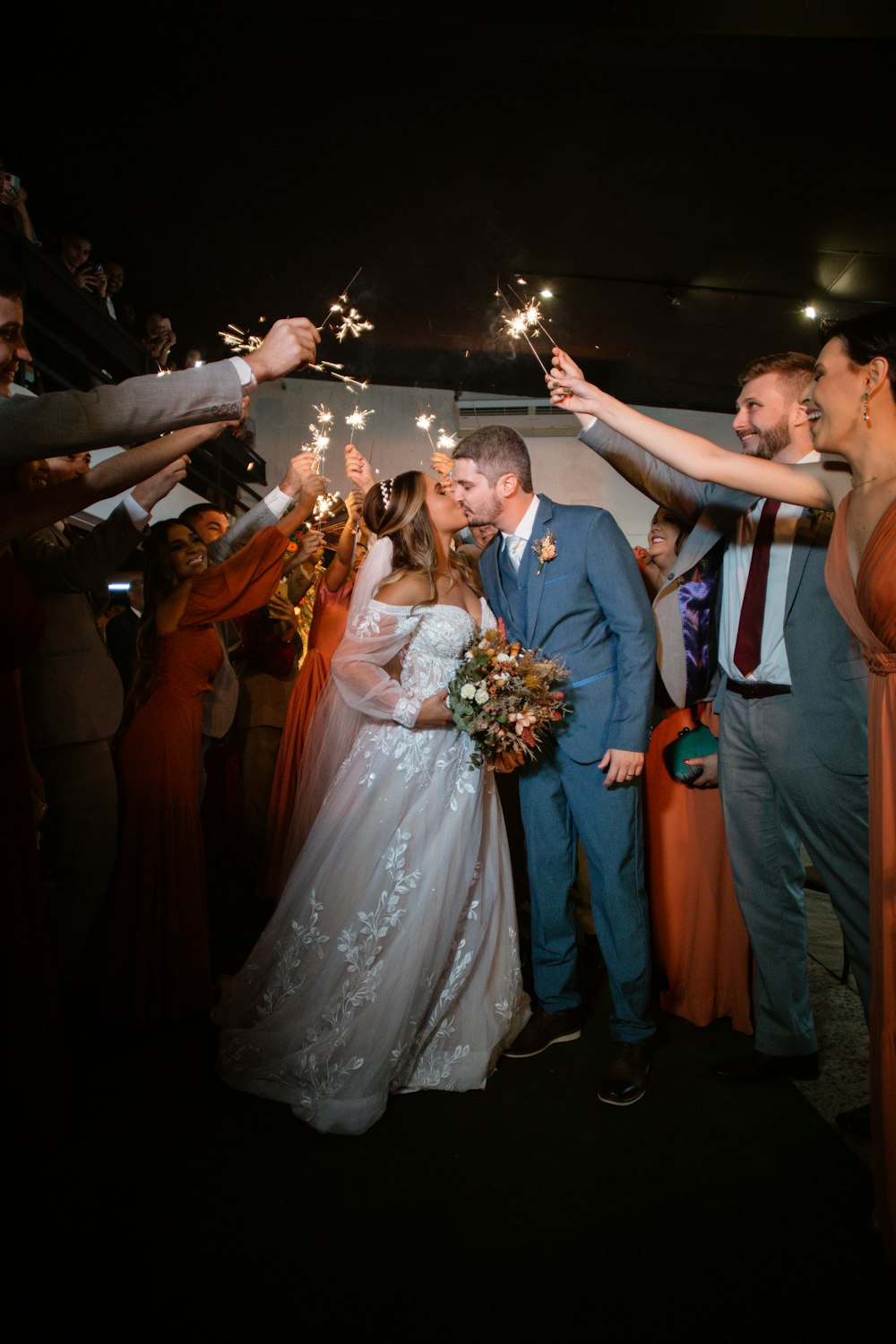 a bride and groom are surrounded by sparklers